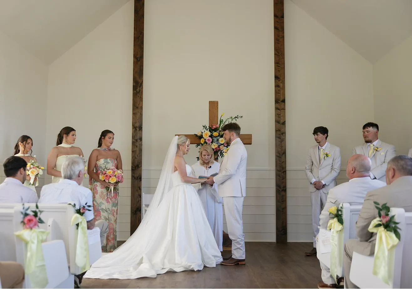 Bailey and Titus exchanging personal vows in the chapel at Gateley Hill Gardens