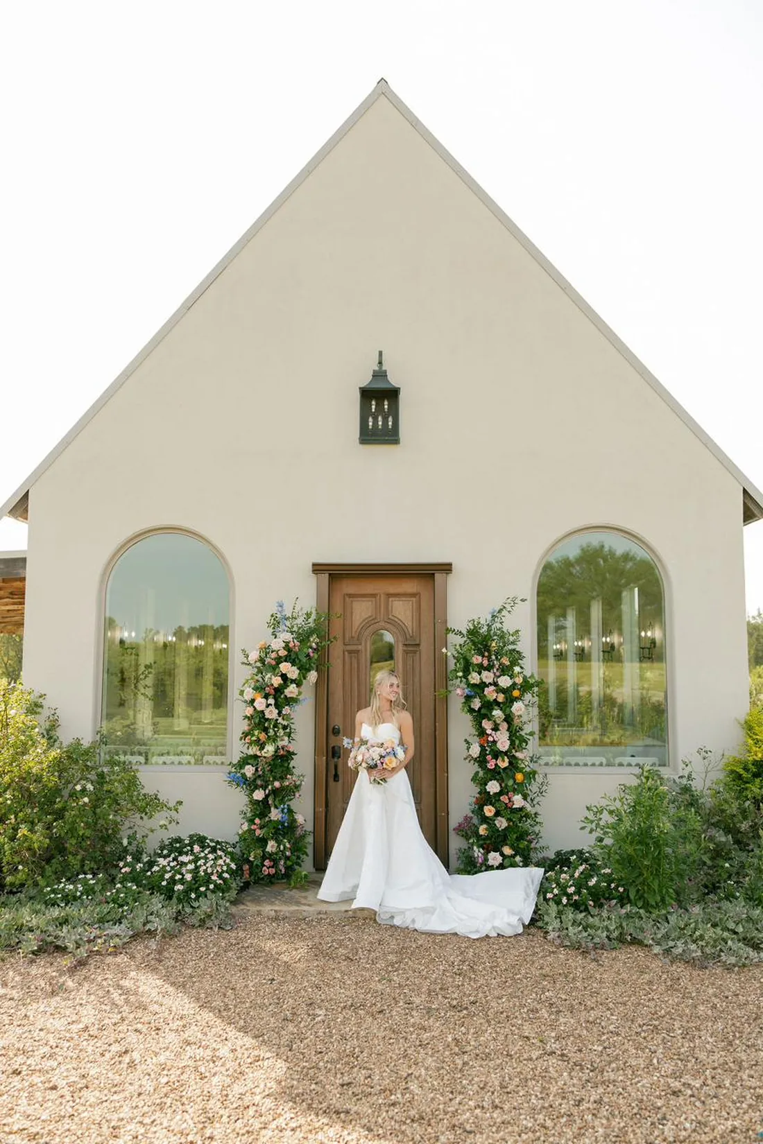 Bride at the white stucco chapel at Gateley Hill Gardens