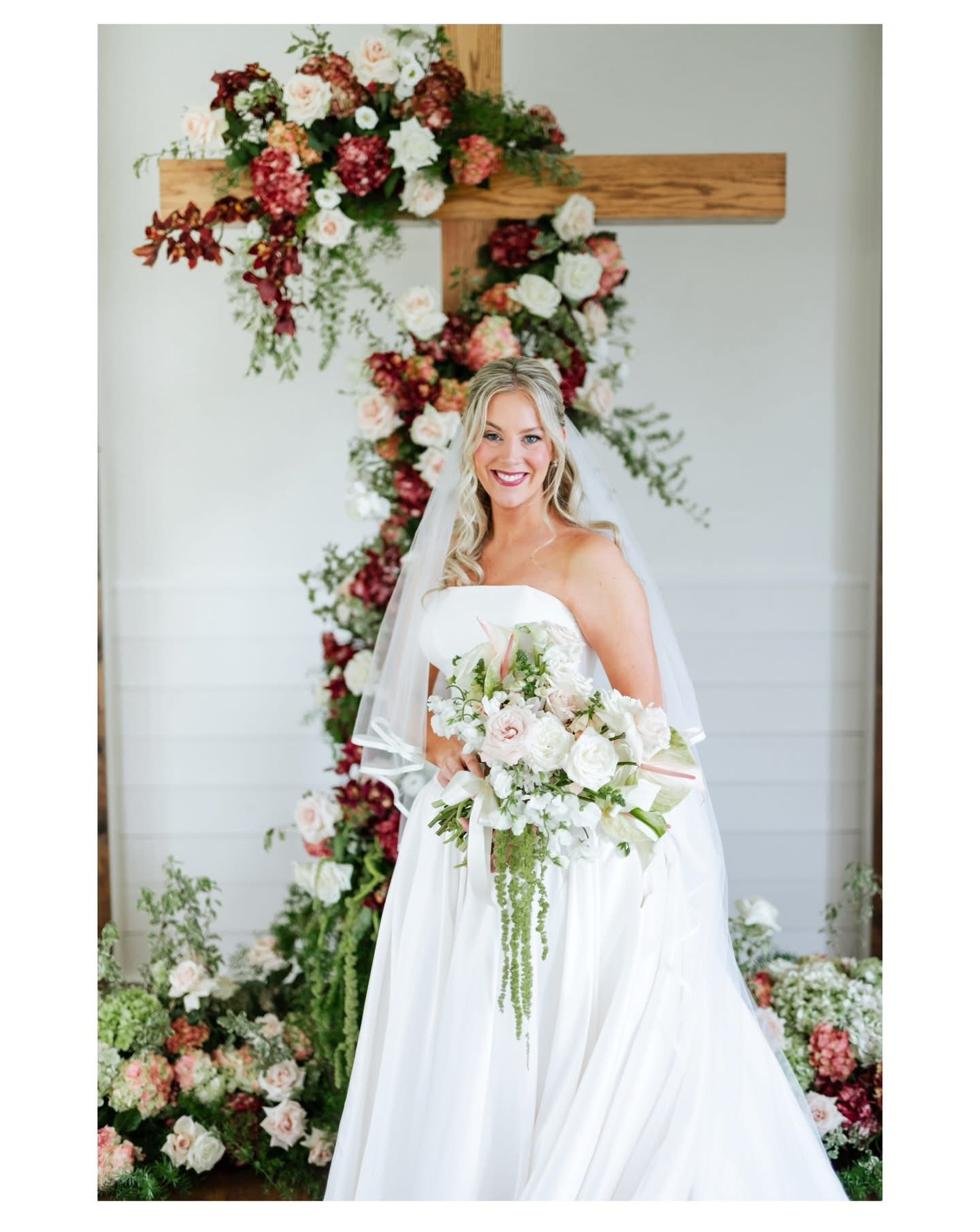 Bride with cross floral installation at Gateley Hill Gardens