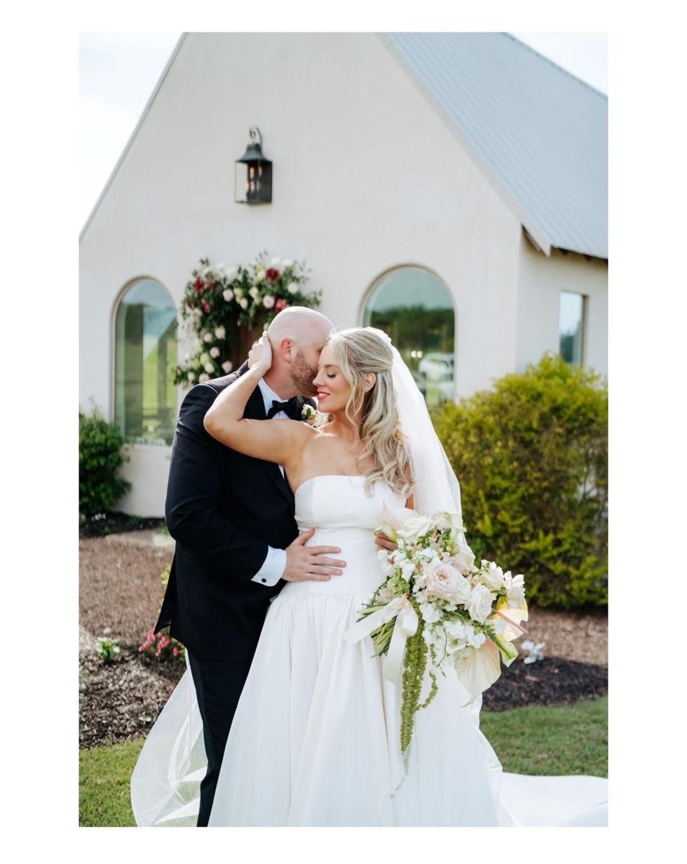 Bride and groom at Gateley Hill Gardens white stucco chapel