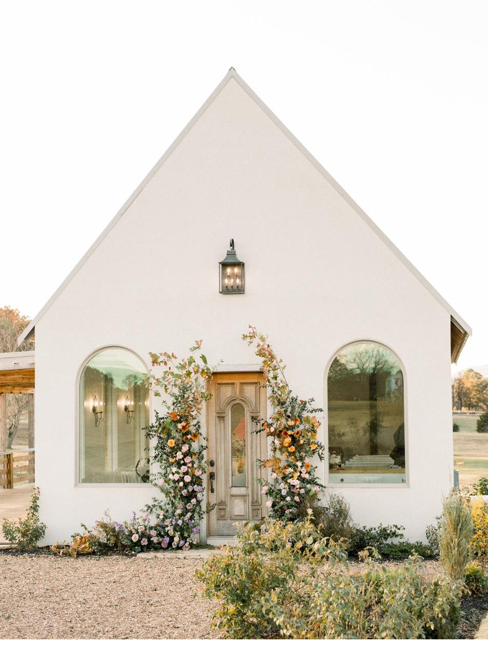 Gateley Hill Gardens white stucco chapel with fall florals, Dardanelle Arkansas