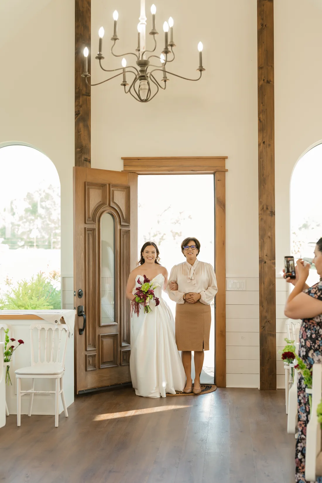 Madisyn entering the chapel with her burgundy bouquet at Gateley Hill Gardens