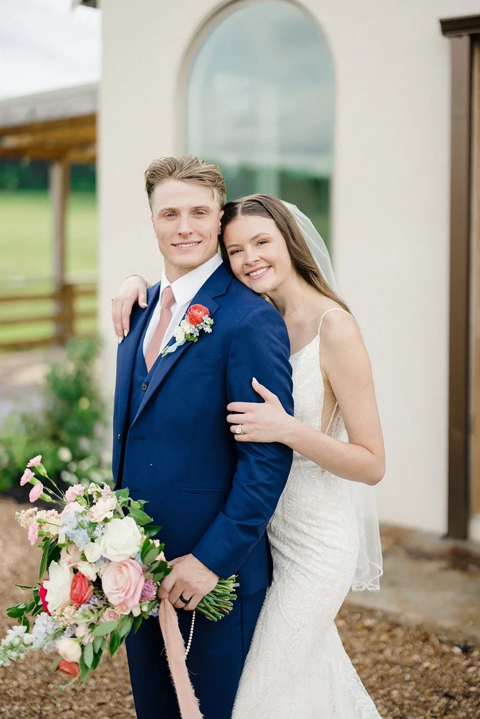 Bride and groom outside the white stucco chapel after their Minimony at Gateley Hill Gardens