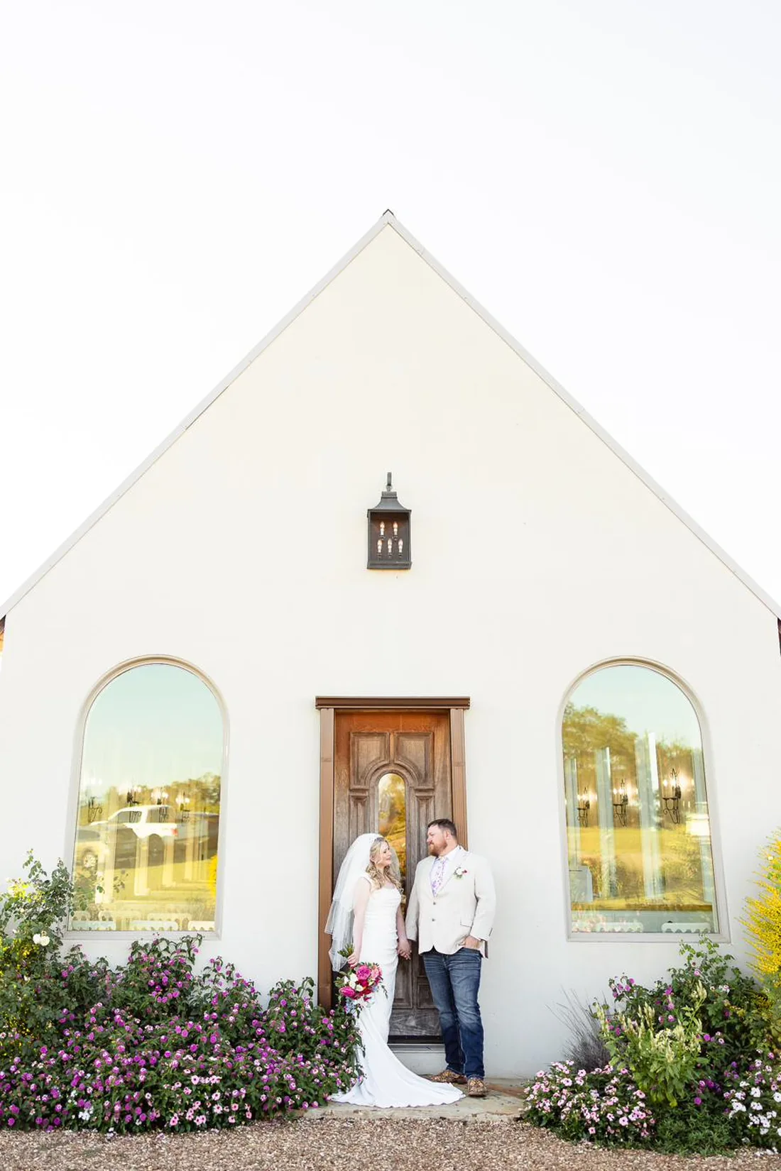Bride and groom at the chapel with rich burgundy fall florals at Gateley Hill Gardens