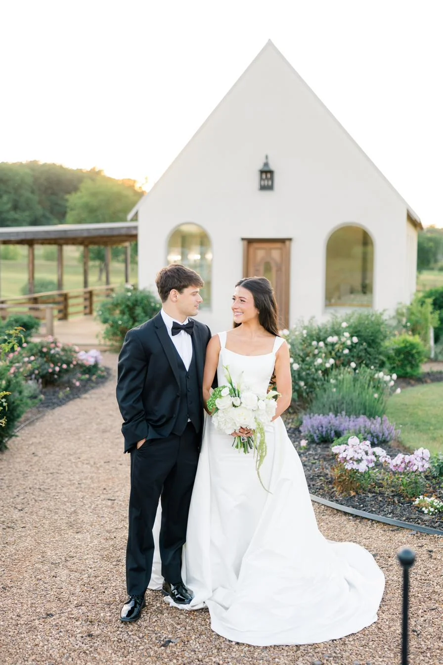 Bride and groom walking through the rose gardens at sunset