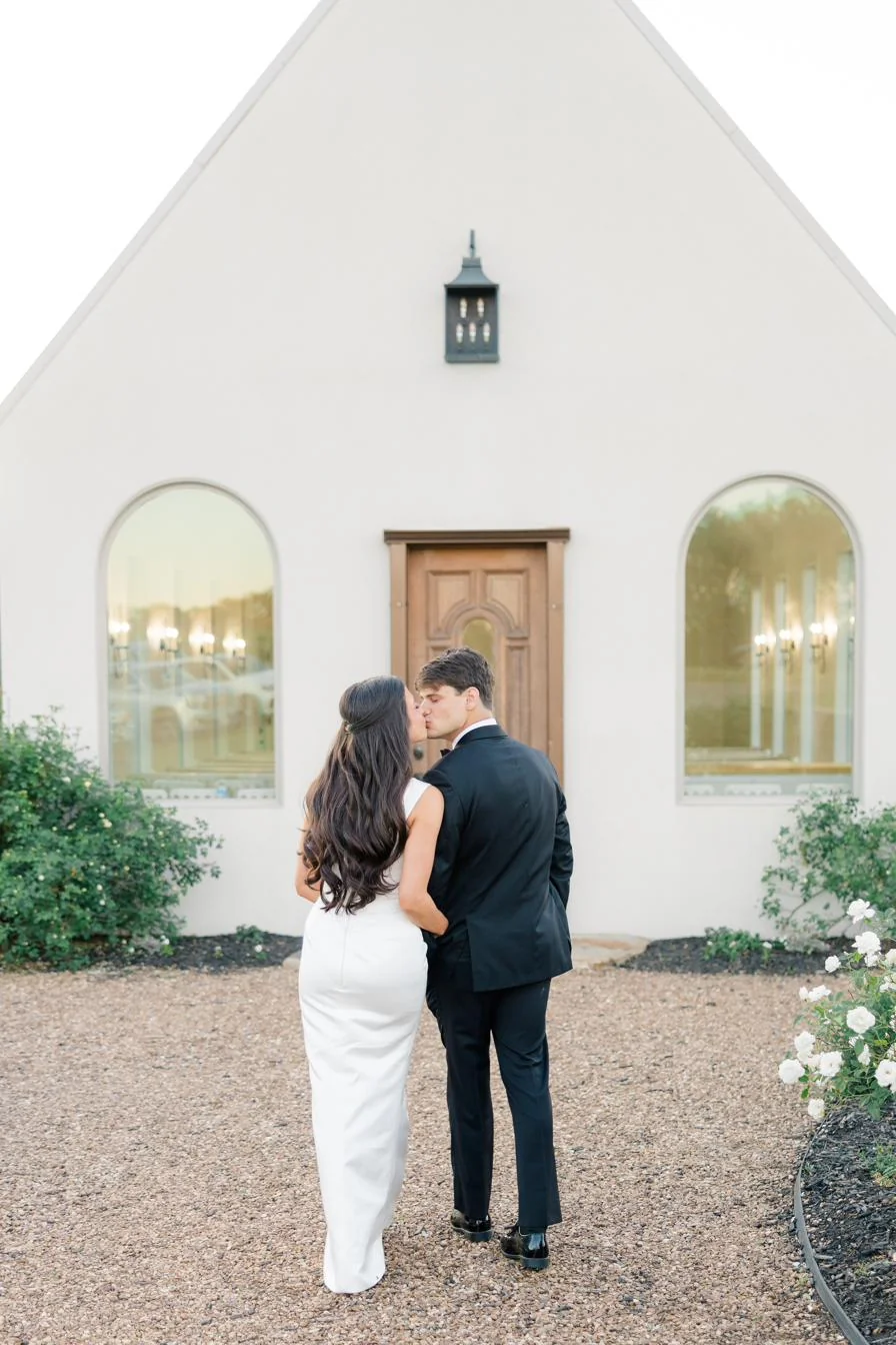 Kiss at the chapel doors at Gateley Hill Gardens