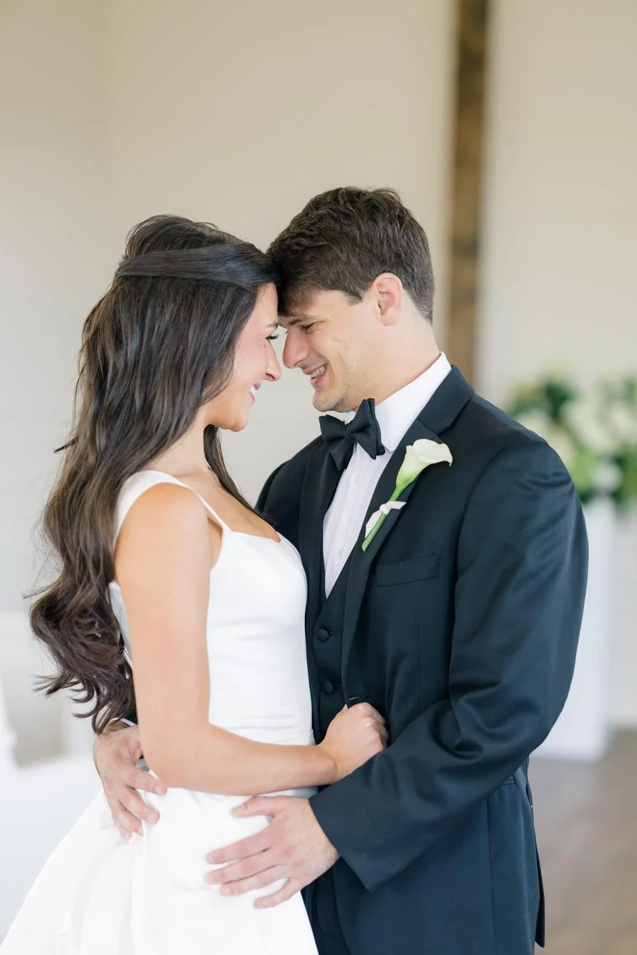 Bride and groom in the chapel with white floral installation at Gateley Hill Gardens