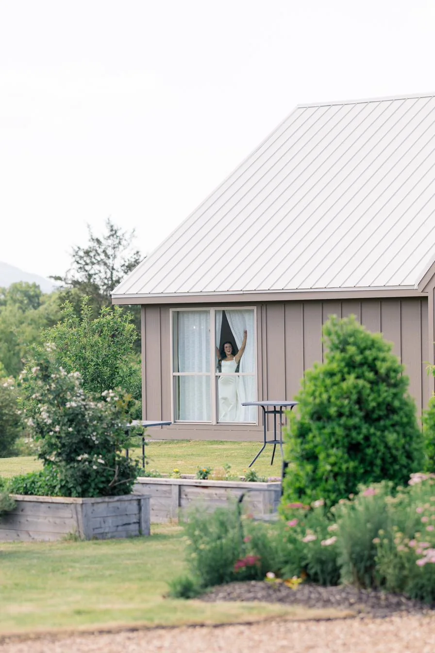 Bride peeking out of the bridal suite at Gateley Hill